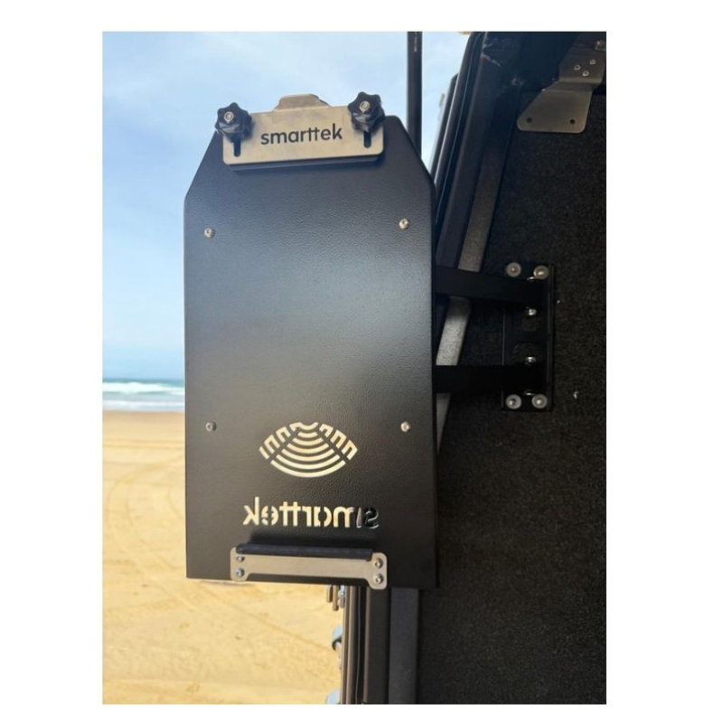 Smarttek Black hot water unit mounted on a swing arm bracket attached to a vehicle.