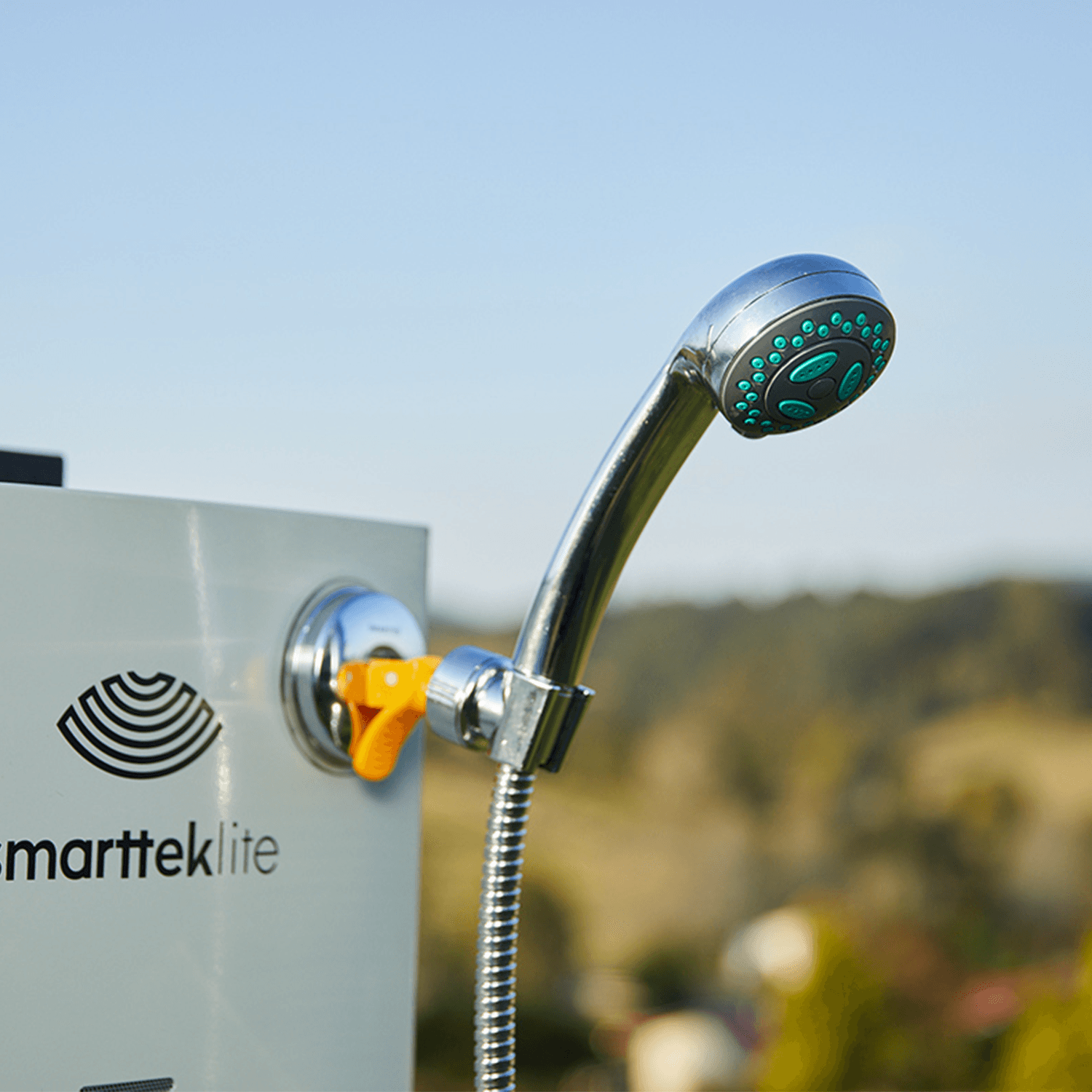 Smarttek shower rose connected to a Smarttek hot water system and hose, shown in outdoor use.