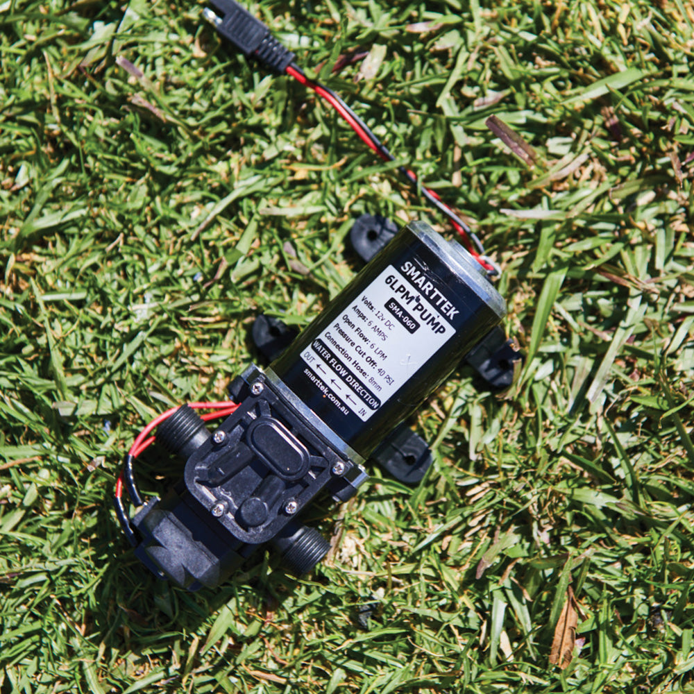 Smarttek 6 litre per minute water pump positioned outdoors on grass