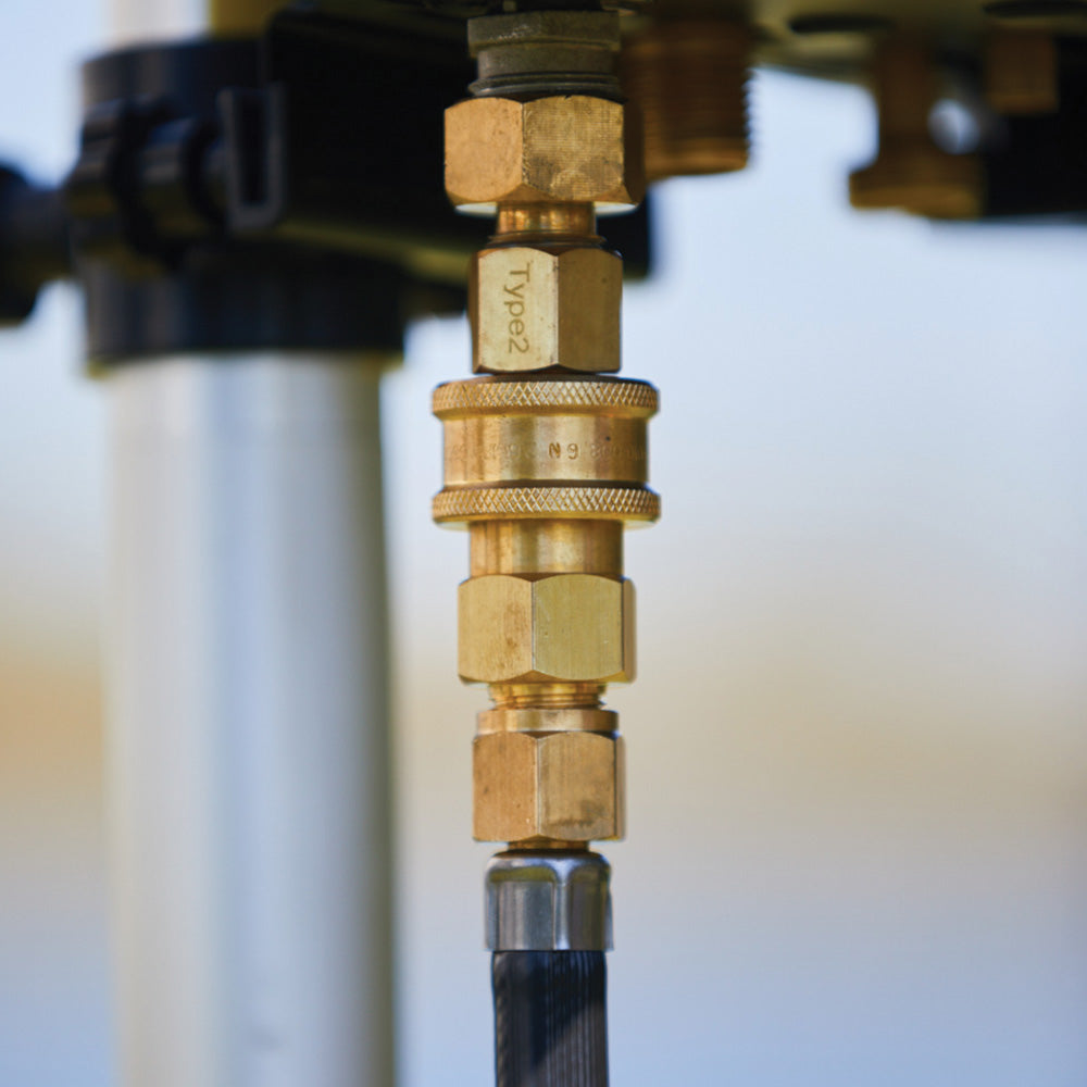 Smarttek LPG quick connect adapter attached to a gas hose under a Smarttek Hot Water System.